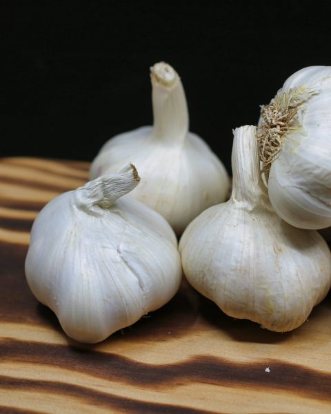 garlic bulbs on brown surface